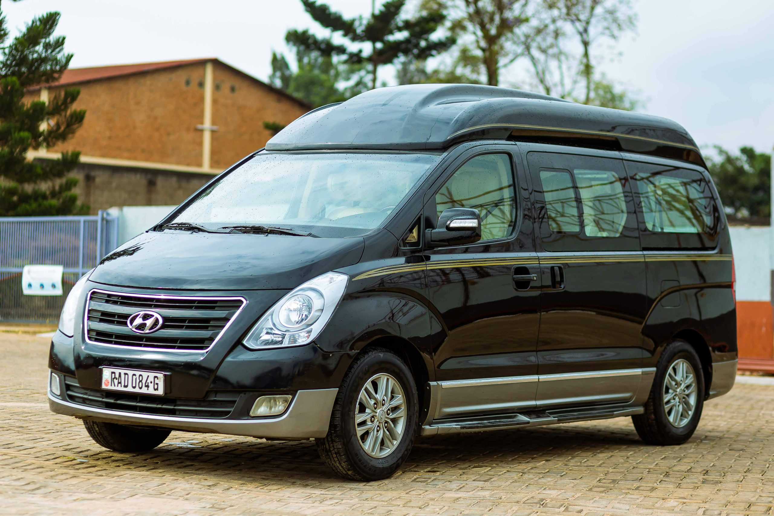 A black Hyundai van parked outdoors in a lot on a clear day.